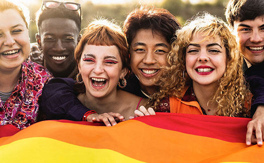 Group of young people holding a pride flag